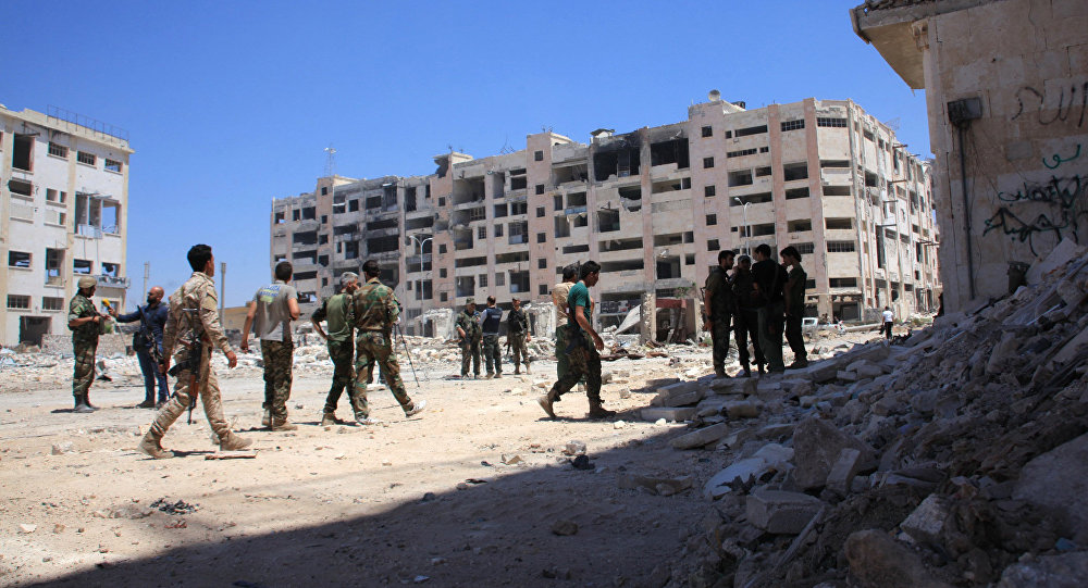 Syrian army soldiers patrol the area around the entrance of Bani Zeid after taking control of the previously rebel-held district of Leramun on the northwest outskirts of Aleppo