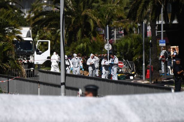 Getty

Forensics officers and policemen look for evidence in a truck on the Promenade des Anglais seafront in the French Riviera town of Nice