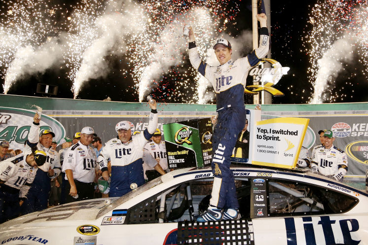 Brad Keselowski celebrates after getting towed to Victory Lane. Racing on reserve fuel he edges Carl Edwards for win No. 4