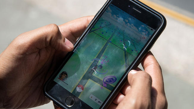 Getty Images File Sameer Uddin plays'Pokemon Go on his smartphone outside of Nintendo's flagship store