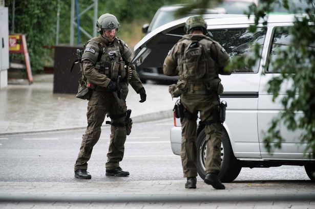 Police secure the area outside a shopping center in Munich