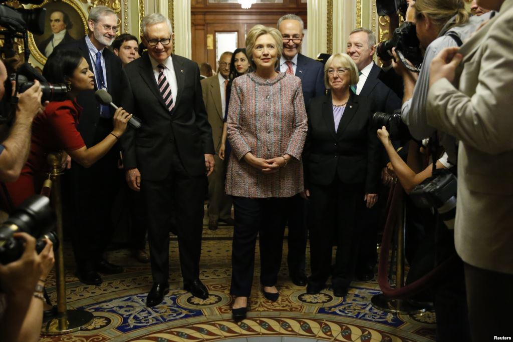 Democratic U.S. presidential candidate Hillary Clinton walks with Senate Minority Leader Harry Reid , Senator Chuck Schumer , Senator Patty Murray  and Senator Dick Durbin  as she arrives to meet