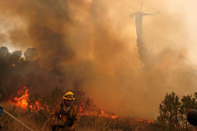 A firefighting helicopter makes a water drop at the so-called Sand Fire in the Angeles National Forest near Los Angeles