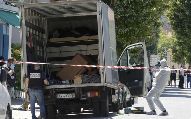 French investigating police conduct a search for clues around a truck the day after a heavy a truck ran into a crowd at high speed killing scores and injuring more who were celebrating the Bastille Day national holiday in Nice France