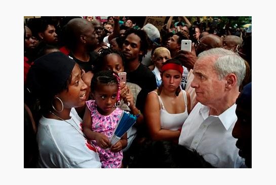 Minnesota Gov. Mark Dayton right meets with people including Diamond Reynolds left and her daughter at the Governor's Mansion in St. Paul Minn. as protesters gathered to decry the shooting death of Reynolds boyfriend Philando Castile by police