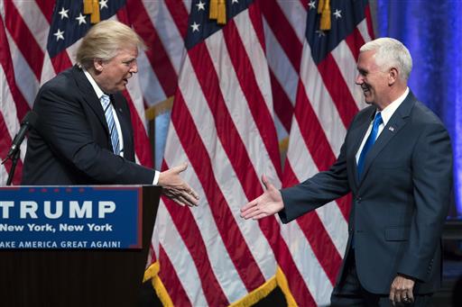 Republican presidential candidate Donald Trump left shakes hands with Gov. Mike Pence R-Ind. during a campaign event to announce Pence as the vice presidential running mate on Saturday