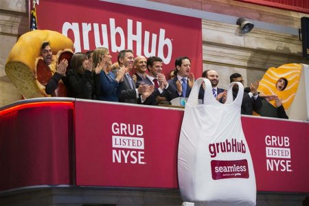 GrubHub CEO Matt Maloney applauds after ringing the opening bell before the company's IPO on the floor of the New York Stock Exchange in New York