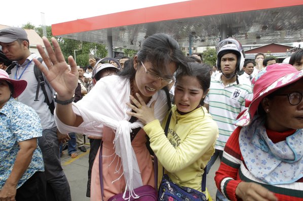 HENG SINITH						Credit AP				Cambodians cry outside a shopping mall where prominent political analyst Kem Ley was shot dead Sunday in Phnom Penh