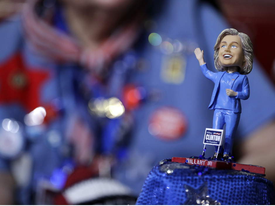 A delegate wears a hat with a bubble-head doll of Democratic Presidential candidate Hillary Clinton during the first day of the Democratic National Convention in Philadelphia