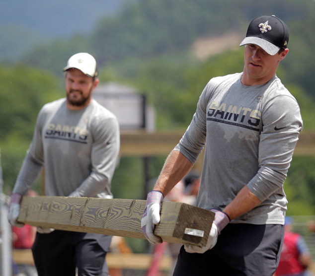 New Orleans Saints punter Thomas Morstead left and quarterback Drew Brees right help clean up Villa Park after the June flooding in White Sulphur Spring