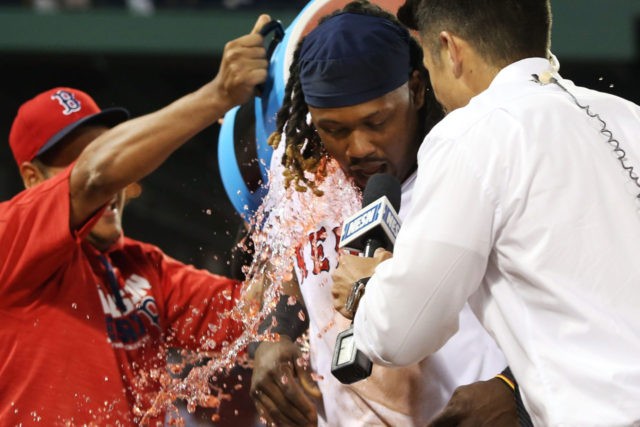 BOSTON MA- JULY 20 Hanley Ramirez #13 of the Boston Red Sox has Powerade dumped on him after their victory over the San Francisco Giants at Fenway Park