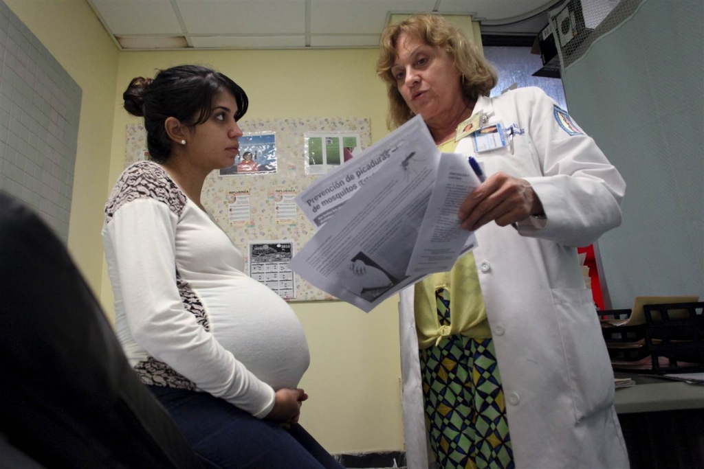 Image Nancy Trinidad who is 32 weeks pregnant listens to the explanation of a doctor about how to prevent Zika Dengue and Chikungunya viruses at a public hospital in San Juan