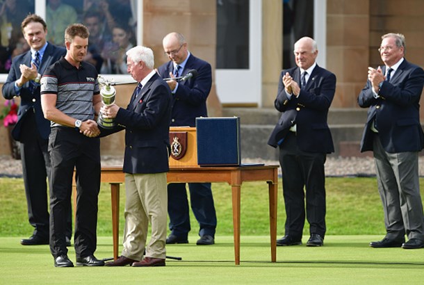 Henrik Stenson of Sweden is presented with the Claret Jug on the the 18th green in front of Todd Hamilton