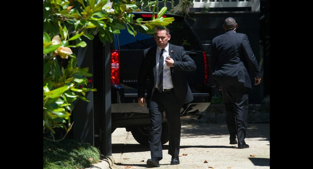 Secret Service stand guard around a Secret Service vehicle after it arrived at the home of Democratic presidential candidate Hillary Clinton in Washington Saturday