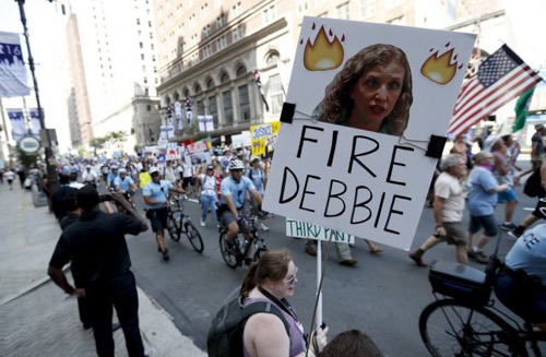 A supporter of Sen. Bernie Sanders holds up a sign calling for Debbie Wasserman Schultz chairwoman of the Democratic National Committee to be fired in Philadelphia