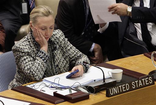 Then-Secretary of State Hillary Clinton checks her mobile phone after her address to the Security Council at United Nations headquarters