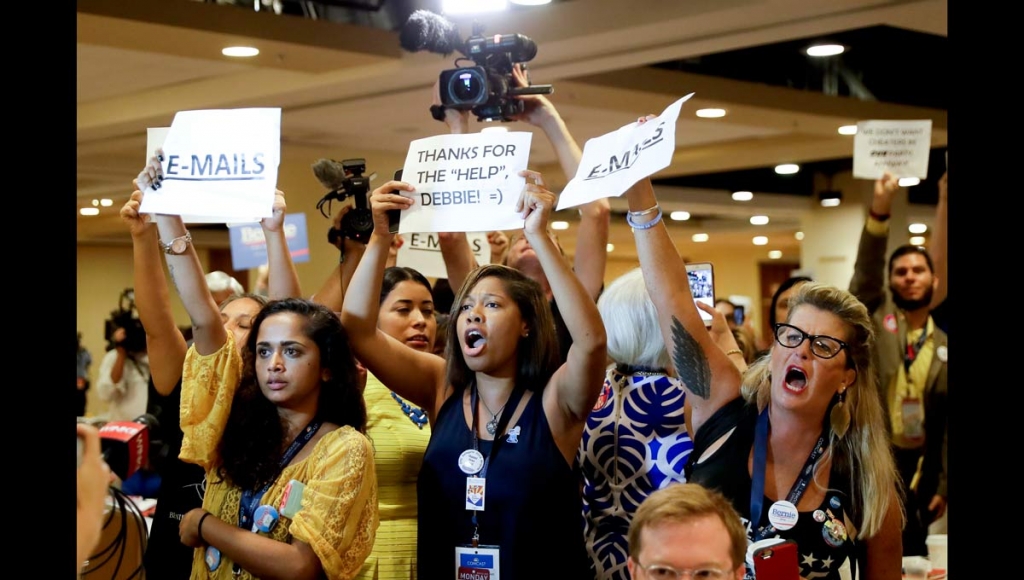 Protesters yell as DNC Chairwoman Debbie Wasserman Schultz D-Fla. arrives for a Florida delegation breakfast Monday