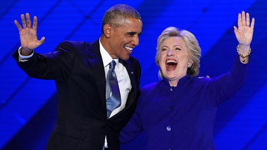 US President Barack Obama stands on stage with Democratic presidential nominee Hillary Clinton on Day 3 of the Democratic National Convention at the Wells Fargo Center