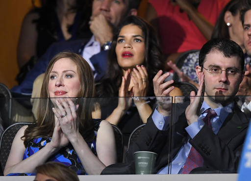 Chelsea Clinton daughter of Democratic Presidential candidate Hillary Clinton left applauds alongside her husband Marc Mezvinsky during the second day of the Democratic National Convention in Philadelphia, Tuesday July