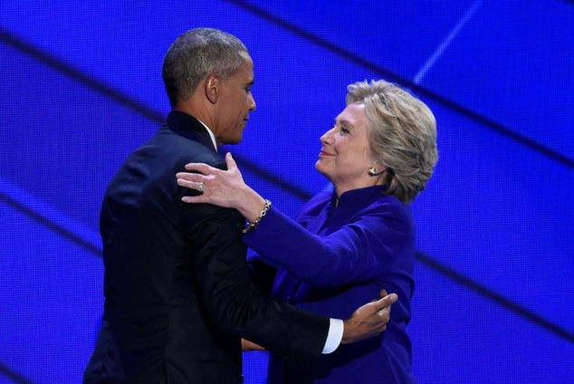 US Democratic presidential nominee Hillary Clinton embraces President Barack Obama on stage during the Democratic National Convention at the Wells Fargo Cent