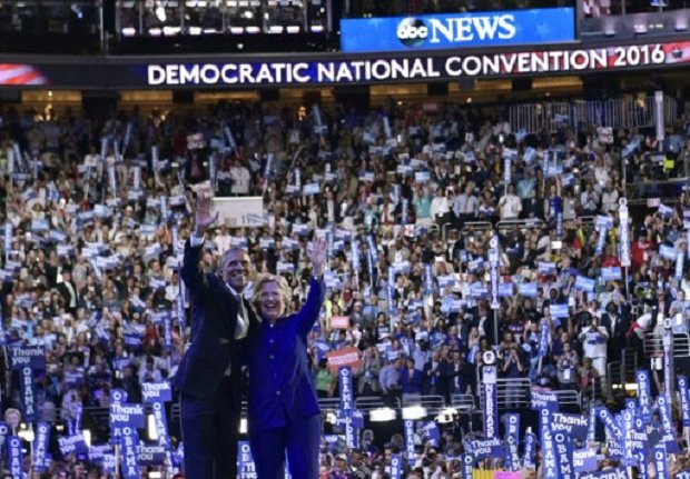 US President Barack Obama is joined by US Democratic presidential candidate Hillary Clinton after his address to the Democratic National Convention at the Wells Fargo Center in Philadelphia Pennsylvania