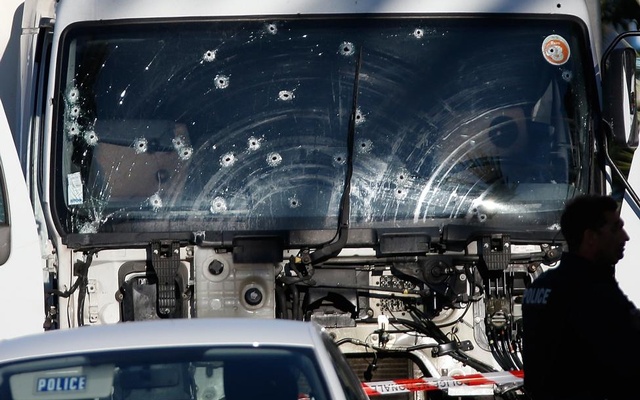 Bullet impacts are seen on the heavy truck the day after it ran into a crowd at high speed killing scores celebrating the Bastille Day July 14 national holiday on the Promenade des Anglais in Nice France