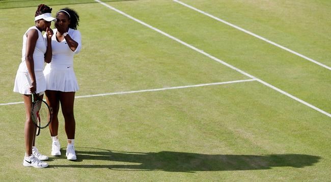 Venus Williams left and Serena Williams of the U.S speak during their women's doubles match against Andrea Hlavackova and Lucie Hradecka of the Czech Republic on day nine of the Wimbledon Tennis Championships in London Tuesday