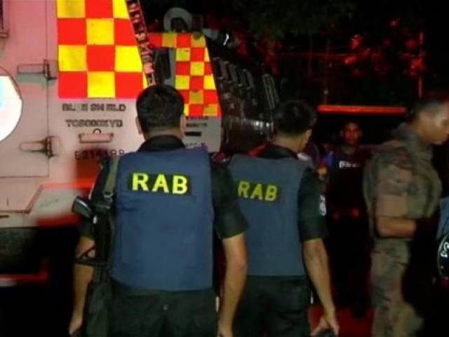 Members of the Rapid Action Battalion are seen outside the Holey Artisan restaurant where gunmen had taken hostages in the upscale Gulshan area of Dhaka Bangladesh