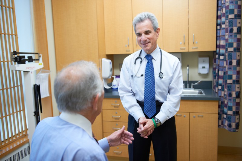 A doctor speaks with a patient who has advanced prostate cancer about inherited mutations