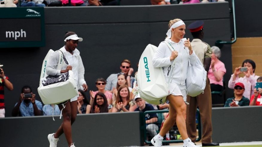 Sloane Stephens of the U.S right and Svetlana Kuznetsova of Russia arrive on court for their women's singles match on during day seven of the Wimbledon Tennis Championships in London Sunday