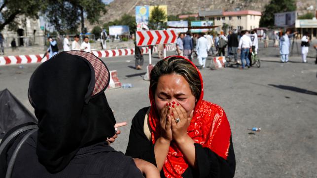 An Afghan woman weeps at the site of a suicide attack in Kabul Afghanistan