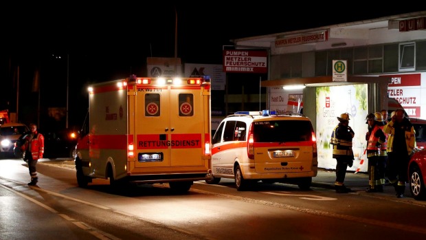 German emergency services workers work in the area where a man with an axe attacked passengers on a train near the city