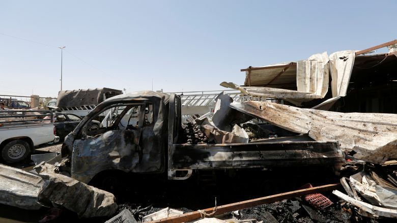 Burnt out vehicles are seen at the site of a car bomb attack in Rashidiya a district north of Baghdad Iraq