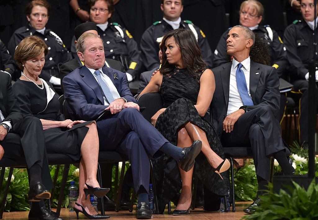 Former first lady Laura Bush, former US president George W. Bush and US President Barack Obama and First Lady Michelle Obama attend an interfaith memorial service for the victims of the Dallas police shooting at the Morton H. Meyerson Symphony C