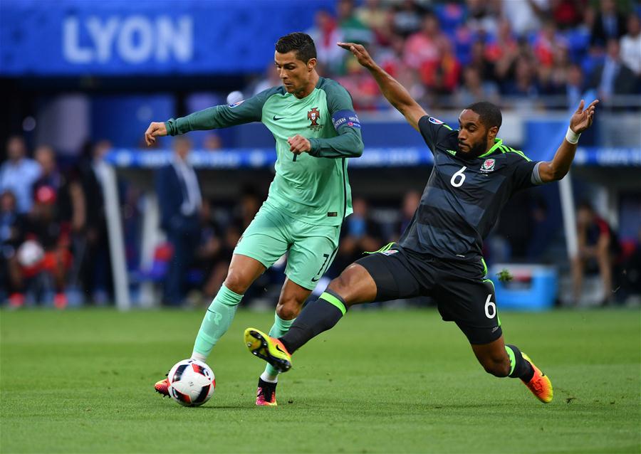 Cristiano Ronaldo of Portugal vies with Ashley Williams of Wales during the Euro 2016 semifinal match between Portugal and Wales in Lyon France