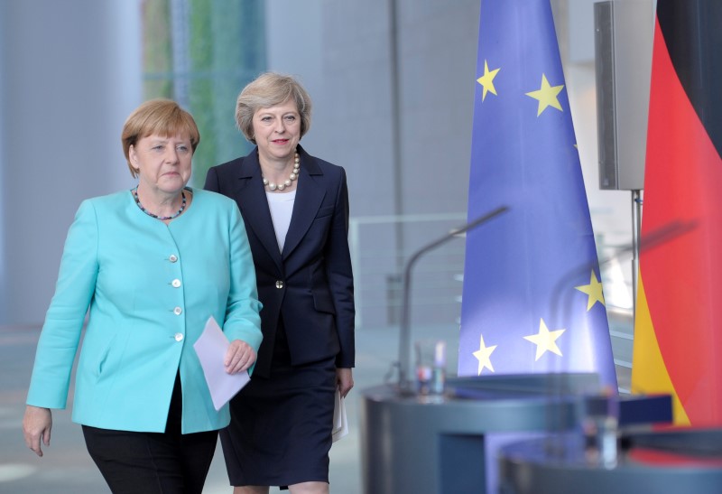 German Chancellor Angela Merkel and British Prime Minister Theresa May arrive for a news conference following talks at the Chancellery in Berlin Germany