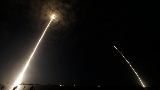 In this time lapse image you can see the Falcon 9 SpaceX rocket lift off and the booster returning on the right