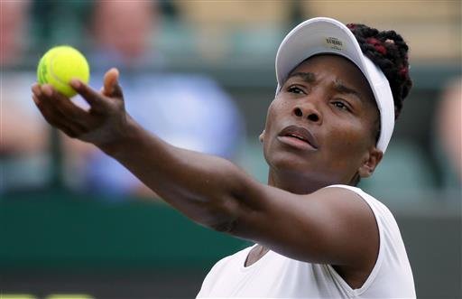 Venus Williams of the U.S serves to Carla Suarez Navarro of Spain during their women's singles match on day eight of the Wimbledon Tennis Championships in London Monday