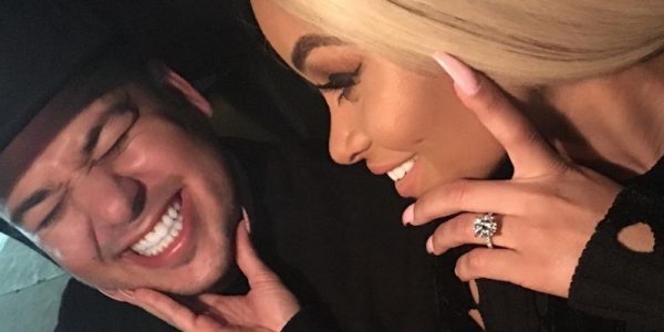 Rob Kardashian smiling wearing hat with Blac Chyna