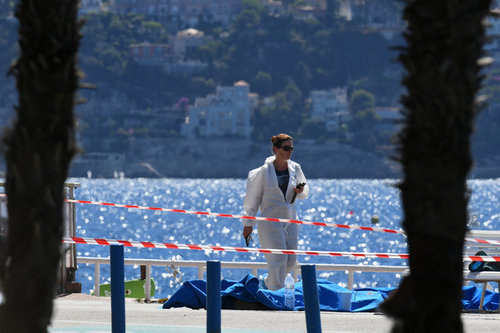 Investigators walk past bodies in Nice following the attack on Bastille Day