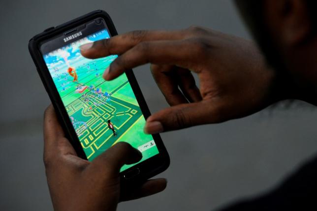 A virtual map of Bryant Park is displayed on the screen as a man plays the augmented reality mobile game''Pokemon Go' by Nintendo in New York City