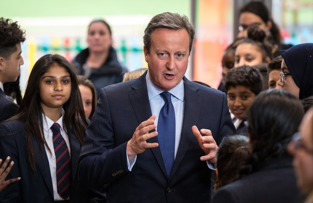 Britain's Prime Minister David Cameron talks to pupils during a visit to Reach Academy Feltham in south west London Tuesday