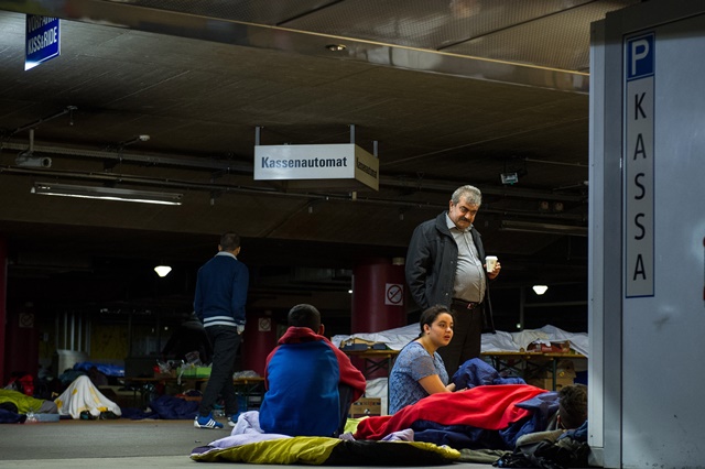 Refugees rest at the parking lot of a railway station in Salzburg Austria on Sept. 14. 2015. German Interior Minister Thomas de Maiziere on Sunday announced that Germany temporarily reinstates border control amid the ongoing refugee crisis. According