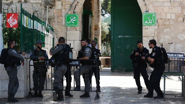 Israeli forces stand at the entrance of the al Aqsa Mosque compound in the Israeli-occupied Old City of al Quds