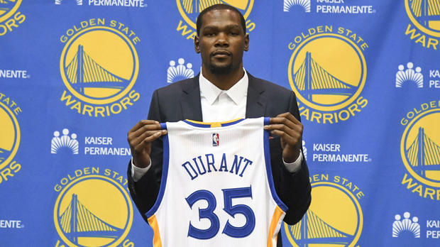 It's still surreal to see Kevin Durant holding a Warriors jersey.                      USATSI