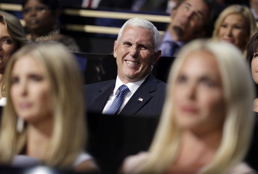 Vice Presidential nominee Gov. Mike Pence of Indiana smiles as he sits during the second day session of the Republican National Convention in Cleveland Tuesday