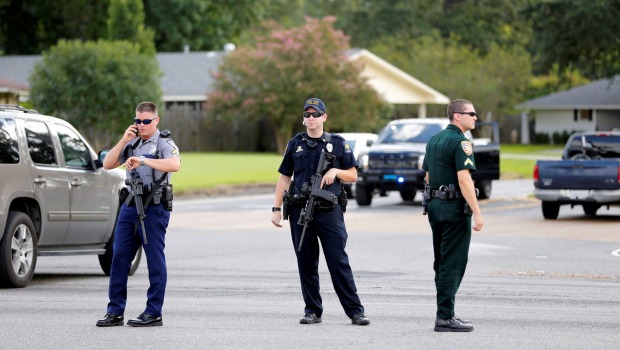 Police officers block off a road after a shooting of police in Baton Rouge Louisiana