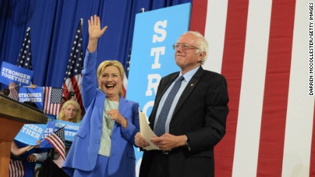 Presumptive Democratic presidential nominee Hillary Clinton and Bernie Sanders take the stage at Portsmouth High School