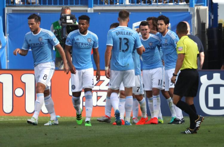 Jack Harrison celebrates with teammates after scoring in the first half against Montreal