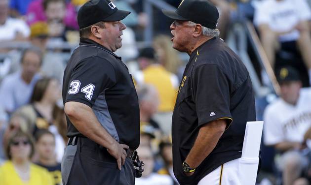 Pittsburgh Pirates manager Clint Hurdle right speaks his mind to umpire Sam Holbrook after being ejected during the first inning of a baseball game against the Milwaukee Brewers in Pittsburgh Wednesday